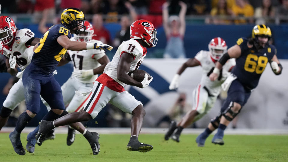 Georgia defensive back Derion Kendrick intercepts a pass intended for Michigan wide receiver Roman Wilson during the first half of the Orange Bowl NCAA College Football Playoff semifinal game, Friday, Dec. 31, 2021, in Miami Gardens, Fla. (AP Photo/Rebecca Blackwell)
