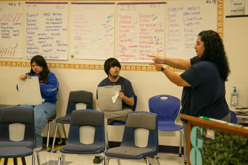 From left, sophomores Clrissa Soto and Christopher Adame try and interpret what their American Sign Language teacher, Jerri-Ann Gonzalez, signs in class at Miller High School Wednesday, Oct. 25, 2023.