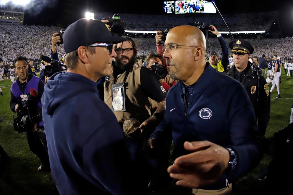Michigan coach Jim Harbaugh, left, and Penn State coach James Franklin meet following the Wolverines' 28-21 loss at Beaver Stadium, Oct. 19, 2019.