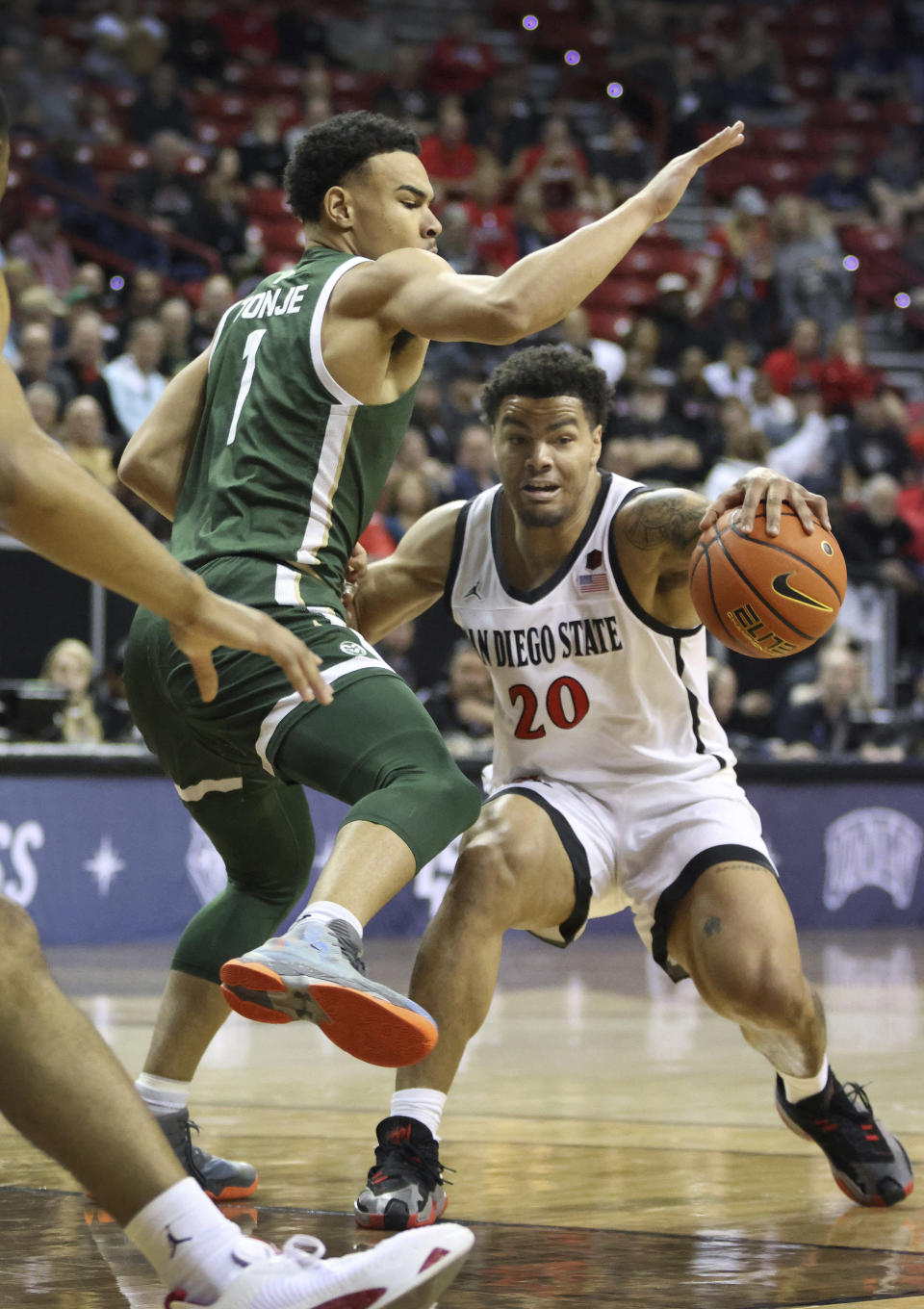 Colorado State guard John Tonje (1) defends as San Diego State guard Matt Bradley (20) drives inside during the first half of an NCAA college basketball game in the quarterfinals of the Mountain West Conference Tournament, Thursday, March 9, 2023, in Las Vegas. (AP Photo/Ronda Churchill)