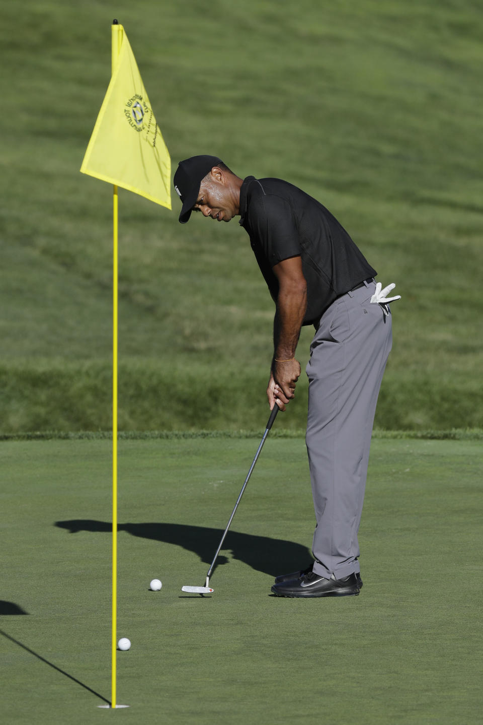 Tiger Woods putts on the 13th green during a practice round for the Memorial golf tournament, Tuesday, July 14, 2020, in Dublin, Ohio. (AP Photo/Darron Cummings)