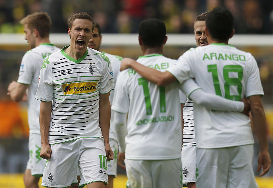Moenchengladbach's Max Kruse, second from left, celebrates with teammates after scoring during the German first division Bundesliga soccer match between BvB Borussia Dortmund and VfL Borussia Moenchengladbach in Dortmund, Germany, Saturday, March 15, 2014. (AP Photo/Frank Augstein)