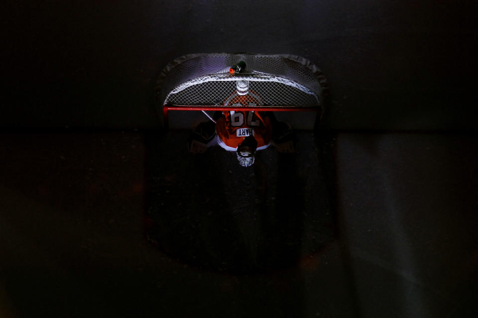 Philadelphia Flyers' Carter Hart sits in goal before an NHL hockey game against the Boston Bruins, Tuesday, March 10, 2020, in Philadelphia. (AP Photo/Matt Slocum)