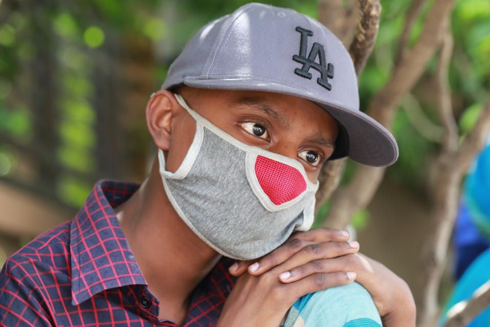 A boy is waiting in front of a hospital to be tested for the COVID-19 coronavirus amid the coronavirus pandemic in Dhaka, Bangladesh on July 1, 2020. (Photo by Rehman Asad/NurPhoto via Getty Images)