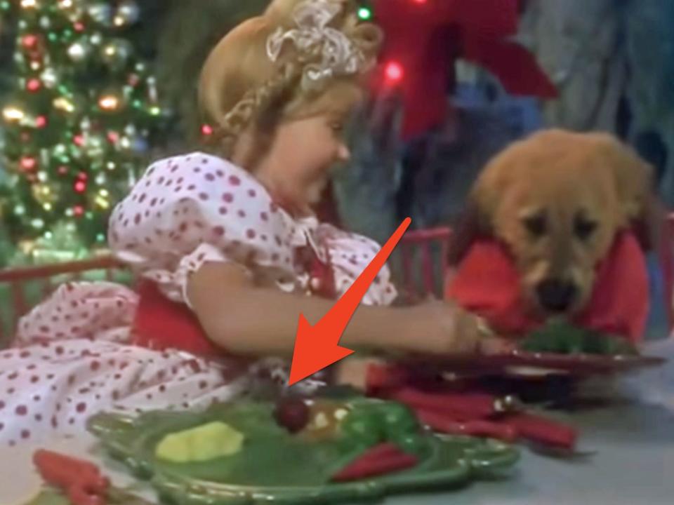 arrow pointing to cindy lu who's plate of green eggs and ham in how the grinch stole christmas