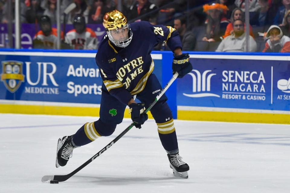 Notre Dame defenseman Drew Bavaro (24) shoots during the first period of an NCAA hockey game against RIT on Saturday, Oct.14, 2023 in Rochester, N.Y. (AP Photo/Adrian Kraus)