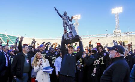 Dec 22, 2018; Birmingham, AL, United States; Wake Forest Demon Deacons head coach Dave Clawson hoists the trophy after defeating the Memphis Tigers 37-34 in the Birmingham Bowl at Legion Field. Mandatory Credit: Butch Dill-USA TODAY Sports