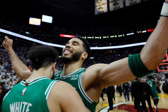 The Boston Celtics & #39;  Derrick White celebrates with Jayson Tatum after defeating the Miami Heat in Game 6.