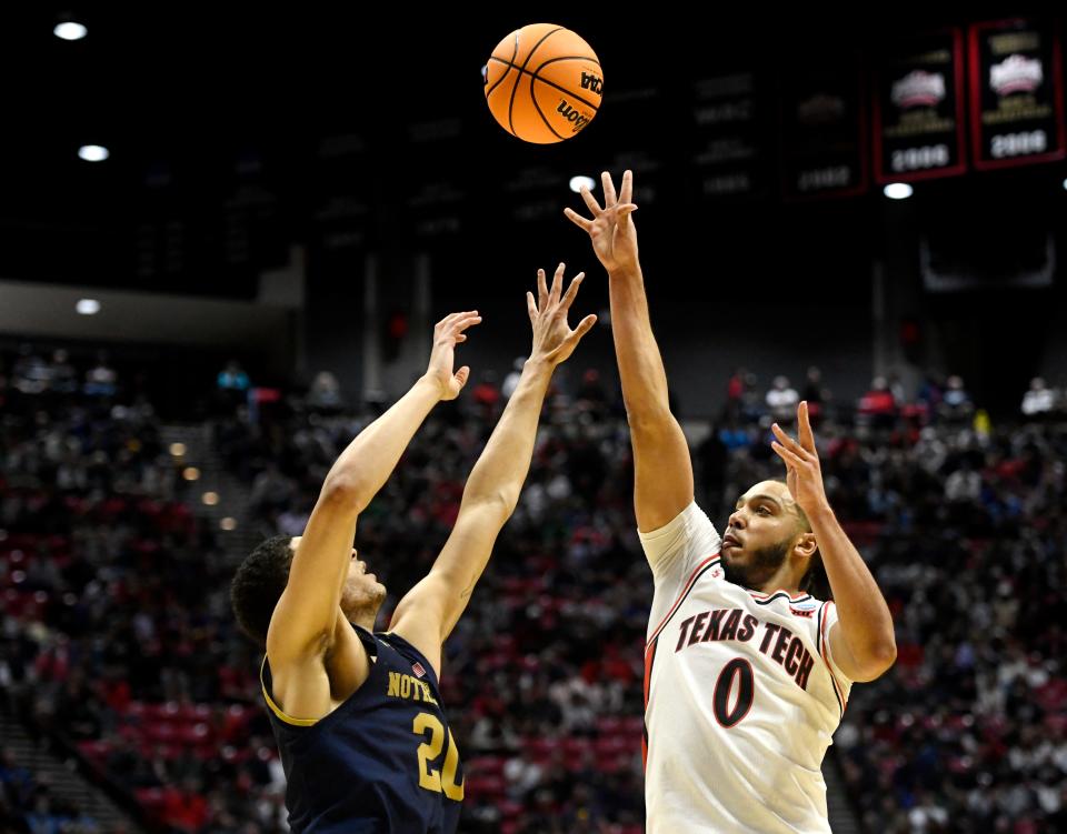 Texas Tech's Kevin Obanor (0) shoots the ball against Notre Dame's Paul Atkionson, Jr. (20) in the NCAA tournament’s second round game, Sunday, March 20, 2022, at Viejas Arena in San Diego, California. 