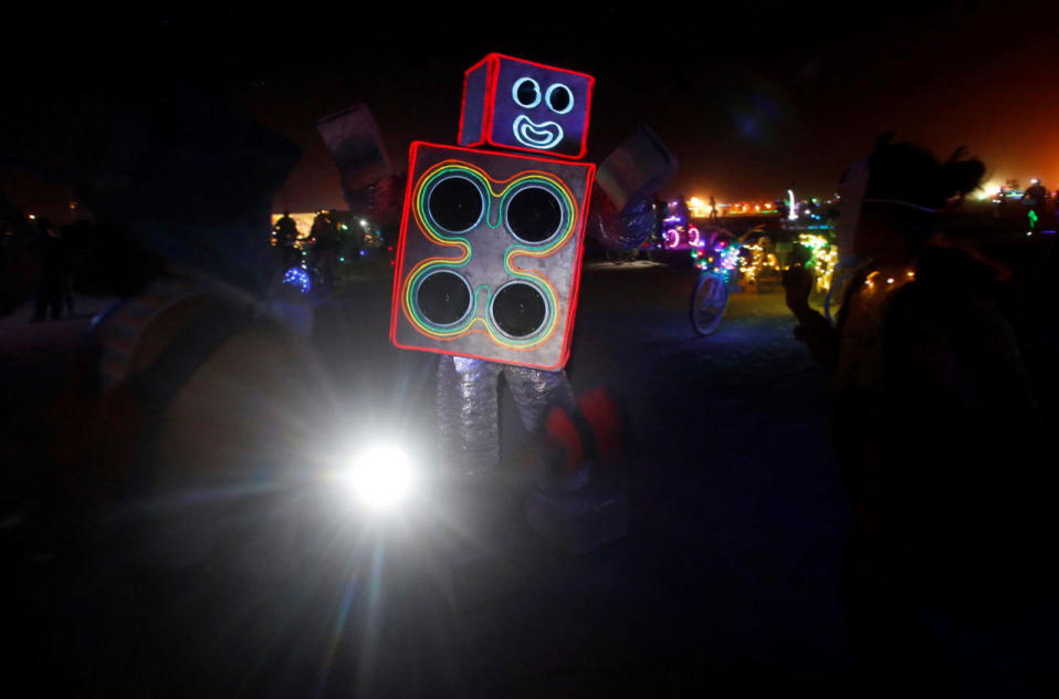 <p>A participant dressed as a robot playing music dances as approximately 70,000 people from all over the world gather for the 30th annual Burning Man arts and music festival in the Black Rock Desert of Nevada, Aug. 29, 2016. (REUTERS/Jim Urquhart)</p>