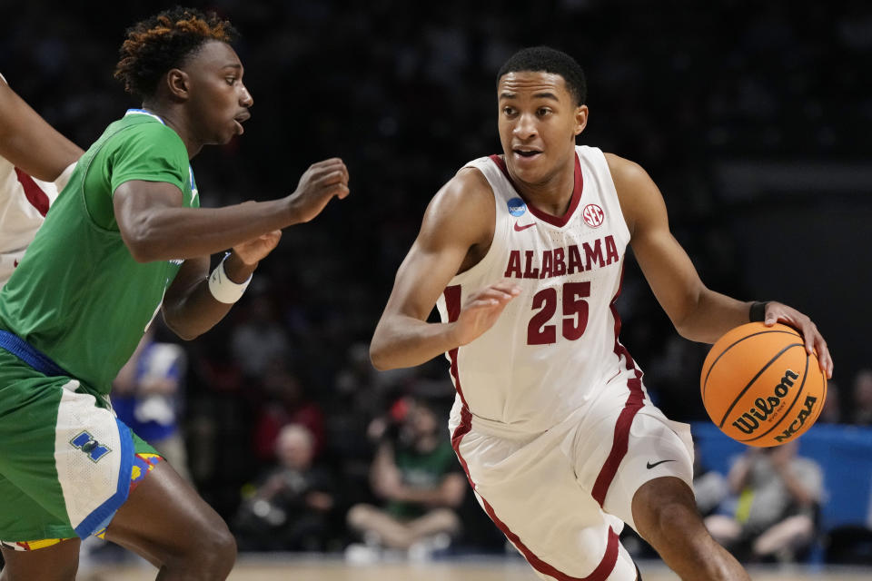 Alabama guard Nimari Burnett (25) turns the corner as he dribbles up court past Texas A&M-CC guard Jalen Jackson, left, in the second half of a first-round college basketball game in the NCAA Tournament in Birmingham, Ala., Thursday, March 16, 2023. Alabama won 96-75. (AP Photo/Rogelio V. Solis)