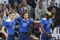 Mix Diskerud (C) of the U.S. celebrates with team mates Aron Johannsson (L) and Gyasi Zardes after scoring a goal against Germany during their international friendly soccer match in Cologne, Germany June 10, 2015. REUTERS/Ina Fassbender