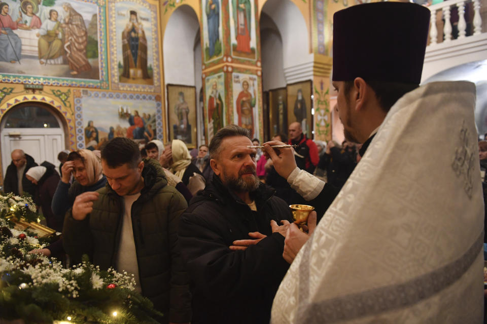 Orthodox believers attend a Christmas service in a church in Zhidkovichi, Gomel region, Belarus, Friday, Jan. 6, 2023. Orthodox Christians celebrate Christmas on Jan. 7, in accordance with the Julian calendar. (AP Photo)