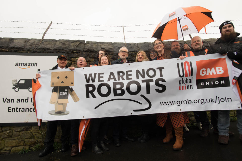 Labour Party leader Jeremy Corbyn (centre) outside an Amazon depot in Sheffield, South Yorkshire, to announce plans for a workers' rights revolution and to ensure big businesses pay their fair share of taxes.