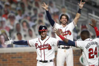 Atlanta Braves' Nick Markakis, left, celebrates with Adeiny Hechavarria (24) after hitting a game-winning home run in the ninth inning of a baseball game against the Atlanta Braves Thursday, Aug. 6, 2020, in Atlanta. (AP Photo/John Bazemore)