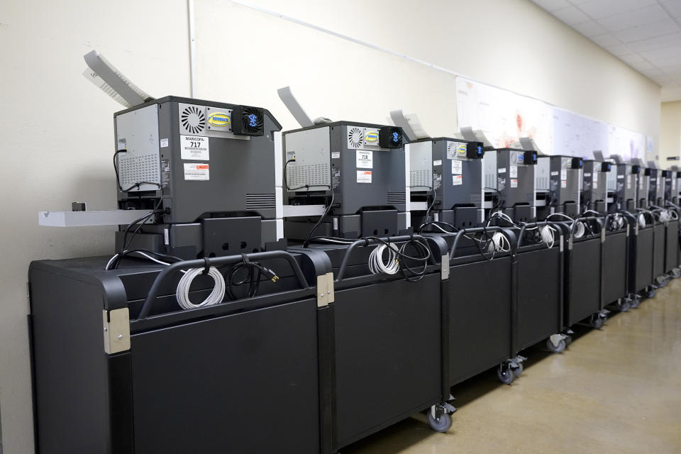 Affidavit printers are lined up at the Maricopa County Elections Department in Phoenix, Thursday, Sept. 8, 2022. Maricopa County election officials, like many others around the country, have begun pushing back against a flood of misinformation related to voting that often leads to public confusion and anger. (AP Photo/Ross D. Franklin)