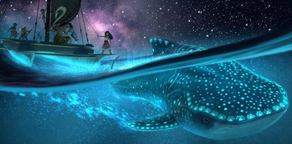 Moana stands on a sailboat's bow over the ocean as a glowing whale passes below. (Courtesy of Disney)