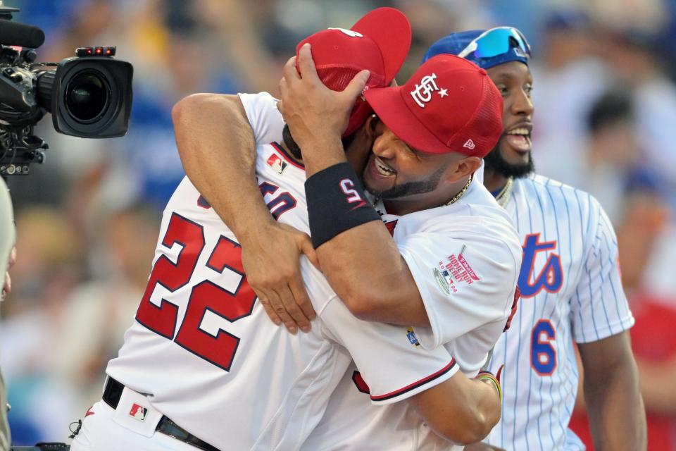 Juan Soto hugs Albert Pujols after defeating him in the Home Run Derby semifinals.