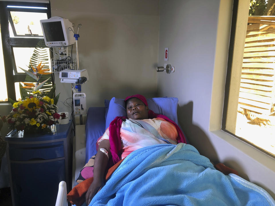 Comedian Samantha Kureya lays in her hospital bed in Harare, Thursday, Aug. 22, 2019. Kureya was abducted from her home, stripped naked and tortured by masked men with assault rifles, for performing skits perceived as being anti-government, the latest in a string of alleged abductions of government critics. (AP Photo/Tsvangirayi Mukwazhi)