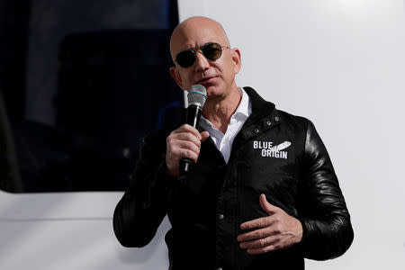 FILE PHOTO: Amazon and Blue Origin founder Jeff Bezos addresses the media about the New Shepard rocket booster and Crew Capsule mockup at the 33rd Space Symposium in Colorado Springs, Colorado, United States April 5, 2017. REUTERS/Isaiah J. Downing/File Photo