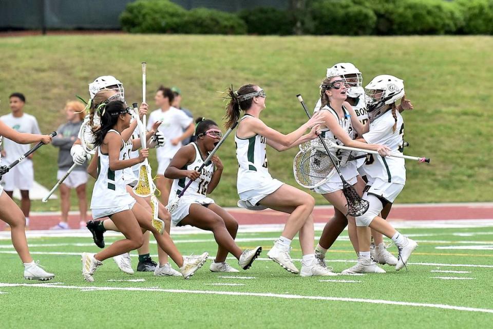 The Cardinal Gibbons’ team celebrates with goalkeeper Addie Brown (39), right, after their victory over Charlotte Catholic in the NCHSAA 4A Lacrosse Final.The Charlotte Catholic Cougars and the Cardinal Gibbons Crusaders met in the NCHSAA 4A Girls Lacrosse Final in Durham , NC on May 19, 2023.