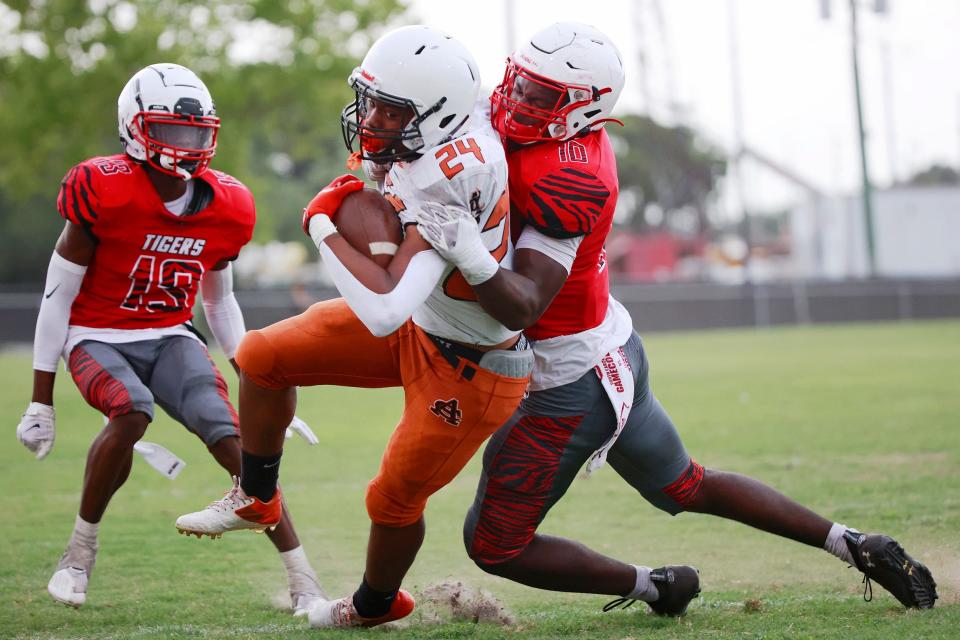 Atlantic Coast's Tyrik Buckholtz (24) is tackled by Andrew Jackson's Grayson Howard (10) during a scrimmage game Friday, May 20, 2022 at Andrew Jackson High School Stadium in Jacksonville. [Corey Perrine/Florida Times-Union]