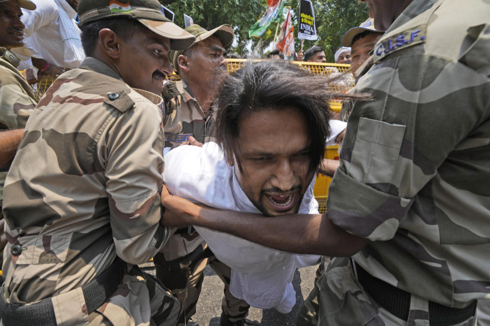 Policemen detain a member of the youth wing of India's Congress party during a protest near Parliament House in New Delhi, India, Thursday, July 20, 2023. The protest was against deadly ethnic clashes in the country's northeast after a video showed two women being assaulted by a mob. The video triggered outrage across India and was widely shared on social media despite the internet being largely blocked in remote Manipur state. (AP Photo/Manish Swarup)