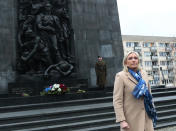 French far-right leader Marine Le Pen, left, pays respects at the memorial to the heroes of the Warsaw Ghetto Uprising, in Warsaw, Poland, Friday Dec. 3, 2021. The memorial honors Jews who rose up against Nazi German forces during World War II. Le Pen is in Warsaw to attend a meeting of the leaders of right-wing and far-right parties on Saturday. (AP Photo/Adam Jankowski)