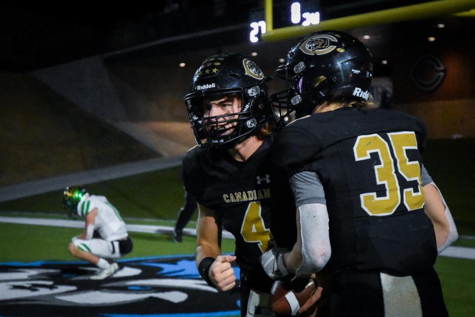 Camren Cavalier (4) celebrates with Luke Flowers (35) after Canadian's 27-24 overtime win over Idalou in the Class 3A Division II bi-district round of playoffs on Nov. 12, 2021 at Happy State Bank Stadium in Canyon.