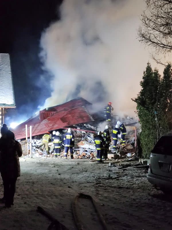 First responders work near the site of a gas explosion that levelled a building in Szczyrk