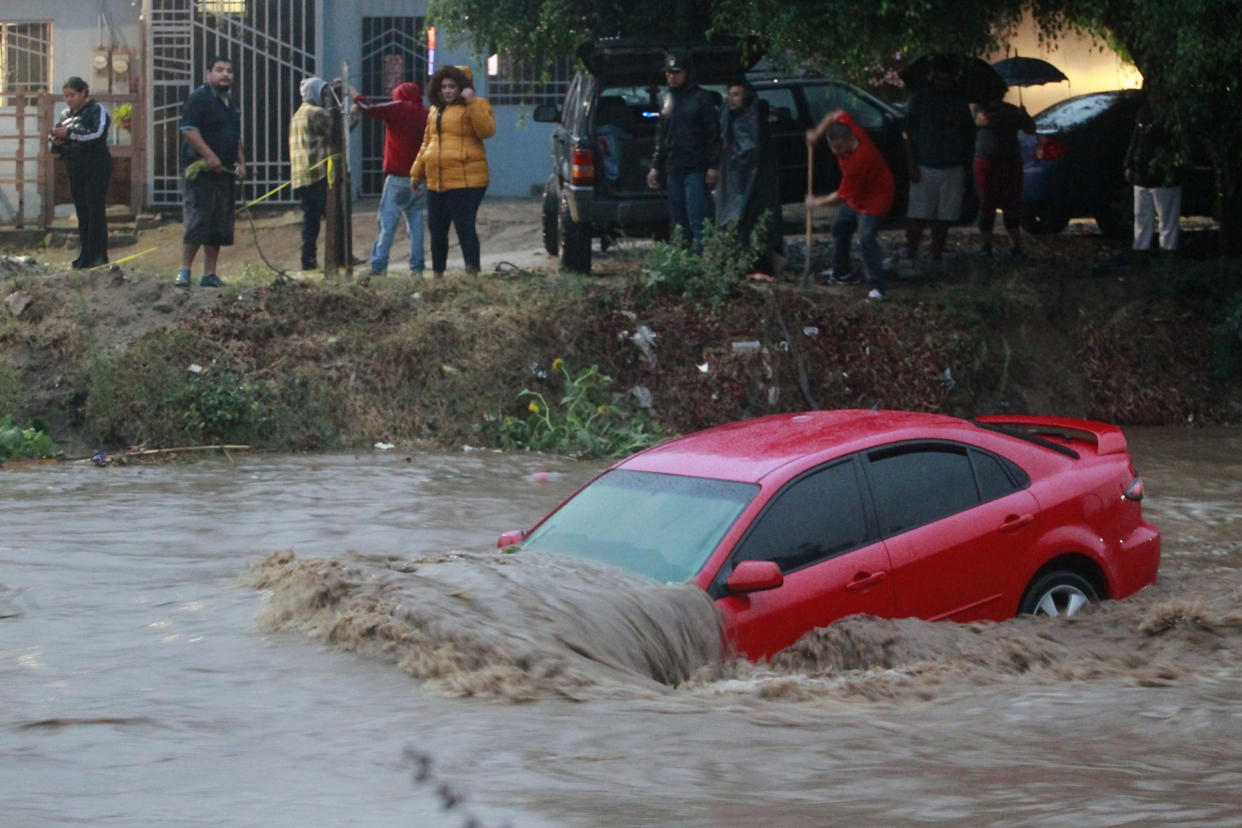 A car floats in floodwater.