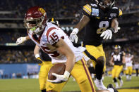 Southern California wide receiver Drake London (15) scores a touchdown ahead of Iowa defensive back Matt Hankins (8) during the first half of the Holiday Bowl NCAA college football game Friday, Dec. 27, 2019, in San Diego. (AP Photo/Orlando Ramirez)