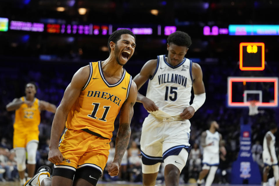 Drexel's Justin Moore (11) reacts past Villanova's Jordan Longino after Drexel won the NCAA college basketball game, Saturday, Dec. 2, 2023, in Philadelphia. (AP Photo/Matt Rourke)