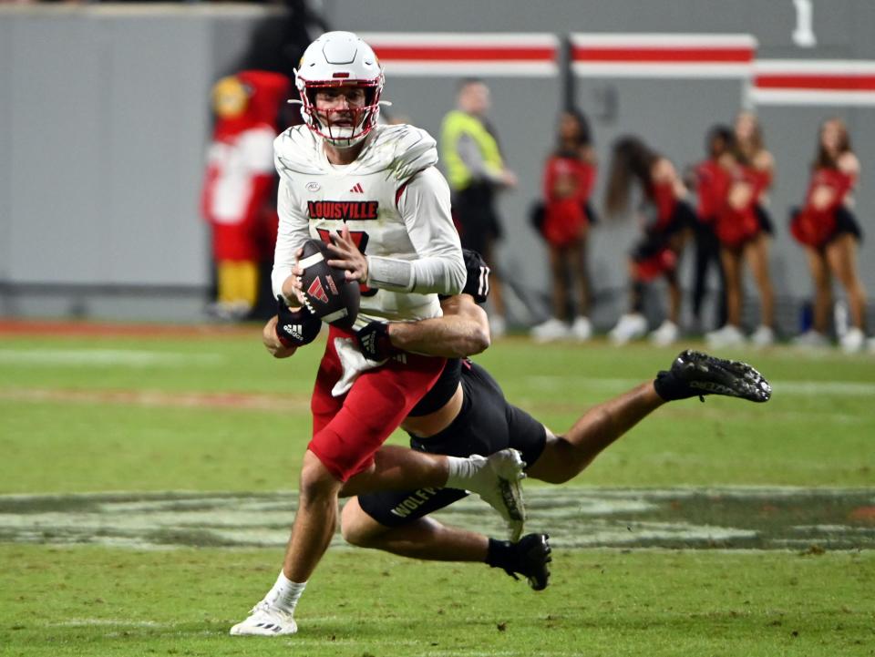 Sep 29, 2023; Raleigh, North Carolina, USA; Louisville Cardinals quarterback Jack Plummer (13) looks to pass as North Carolina State Wolfpack linebacker Payton Wilson (11) defends during the second half at Carter-Finley Stadium. The Louisville Cardinals won 13-10. Mandatory Credit: Rob Kinnan-USA TODAY Sports