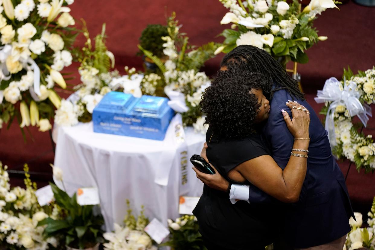 Mourners embrace before a memorial service for Ruth Whitfield, a victim of the Buffalo supermarket shooting, at Mt. Olive Baptist Church with Vice President Kamala Harris and her husband Doug Emhoff in attendance, Saturday, May 28, 2022, in Buffalo, N.Y. (AP Photo/Patrick Semansky) ORG XMIT: NYPS102