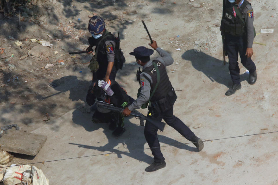 FILE - In this March 6, 2021, file photo, riot police officers hold down a protester as they disperse protesters in Tharkata Township on the outskirts of Yangon, Myanmar. The military takeover of Myanmar early in the morning of Feb. 1 reversed the country's slow climb toward democracy after five decades of army rule. But Myanmar's citizens were not shy about demanding their democracy be restored. (AP Photo, File)