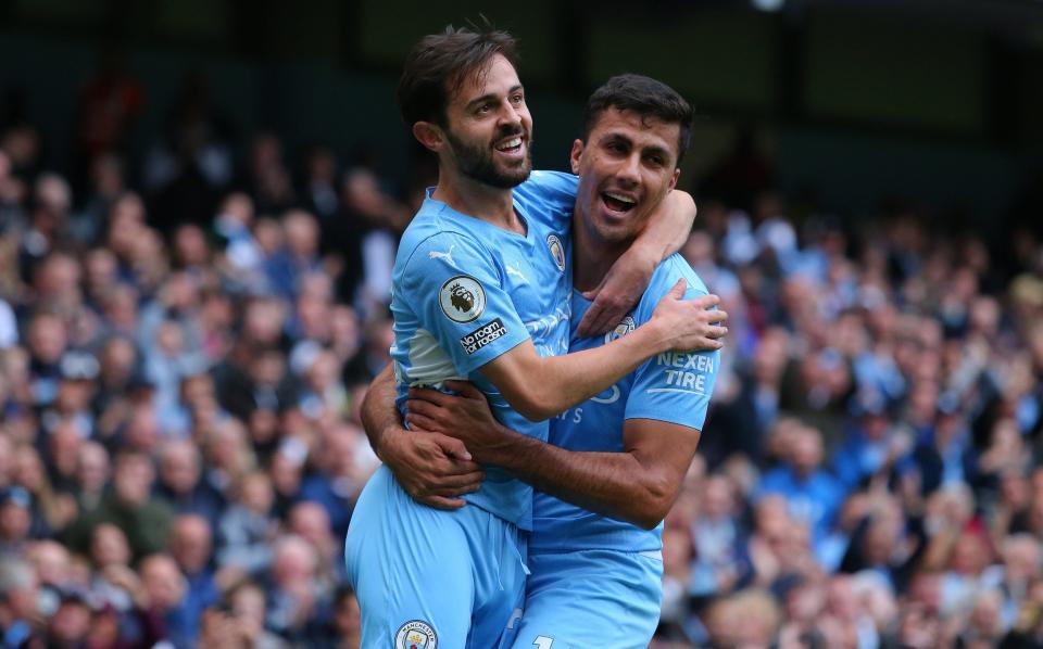 Bernardo Silva of Manchester City celebrates with Rodri after scoring the opening goal during the Premier League match between Manchester City and Burnley at Etihad Stadium on October 16, 2021 in Manchester, England. - GETTY IMAGES