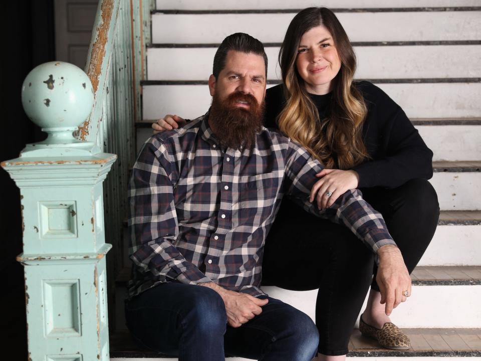 A photo of Candis and Andy Meredith sitting on a staircase.