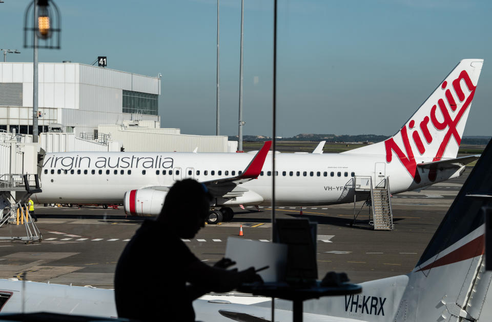 A Virgin Australia plane sitting on the tarmac at Sydney airport.