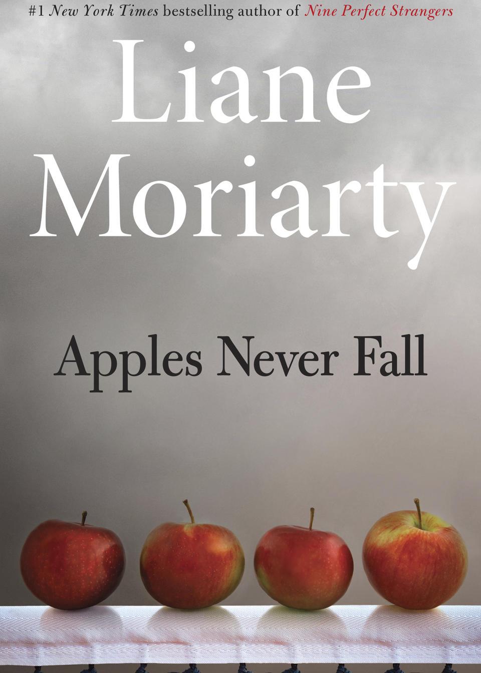 This cover image released by Henry Holt & Company shows "Apples Never Fall" by Liane Moriarty. (Henry Holt & Company via AP)