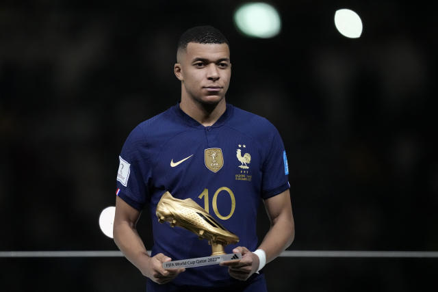 France's Kylian Mbappe holds the Golden Boot award for top goalscorer of the tournament after the World Cup final soccer match between Argentina and France at the Lusail Stadium in Lusail, Qatar, Sunday, Dec. 18, 2022. Argentina won 4-2 in a penalty shootout after the match ended tied 3-3. (AP Photo/Martin Meissner)