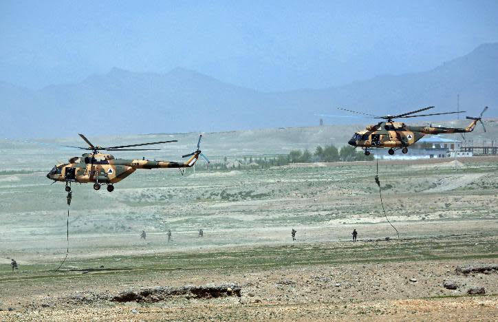 Afghan National Army (ANA) helicopters deploy soldiers during a military exercise on the outskirts of Kabul, Afghanistan, Wednesday, April 30, 2014. The Afghan National Security Forces depend exclusively on billions of dollars in funding from the United States and its allies, money that is now at risk after President Hamid Karzai's refusal to sign a security agreement to keep a small U.S. force of trainers in the country after the NATO-led coalition ends its mission and withdraws at the end of the year. (AP Photo/Massoud Hossaini)