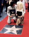<p>Stallone was honored with a prestigious star on the Hollywood Walk of Fame on June 14, 1984. The actor was inducted alongside country music legend and former costar <a href="https://people.com/tag/dolly-parton/" rel="nofollow noopener" target="_blank" data-ylk="slk:Dolly Parton;elm:context_link;itc:0;sec:content-canvas" class="link ">Dolly Parton</a>.</p> <p>The two took the lead in 1984's <a href="https://people.com/archive/picks-and-pans-review-rhinestone-vol-22-no-2/?amp=true" rel="nofollow noopener" target="_blank" data-ylk="slk:Rhinestone;elm:context_link;itc:0;sec:content-canvas" class="link "><i>Rhinestone</i></a>, a film that chronicles a country music singer (Parton) and her pursuit to turn the next person she sees into a Nashville-style crooner — that person being Stallone's character, a tough New Yorker who can't sing a note.</p>