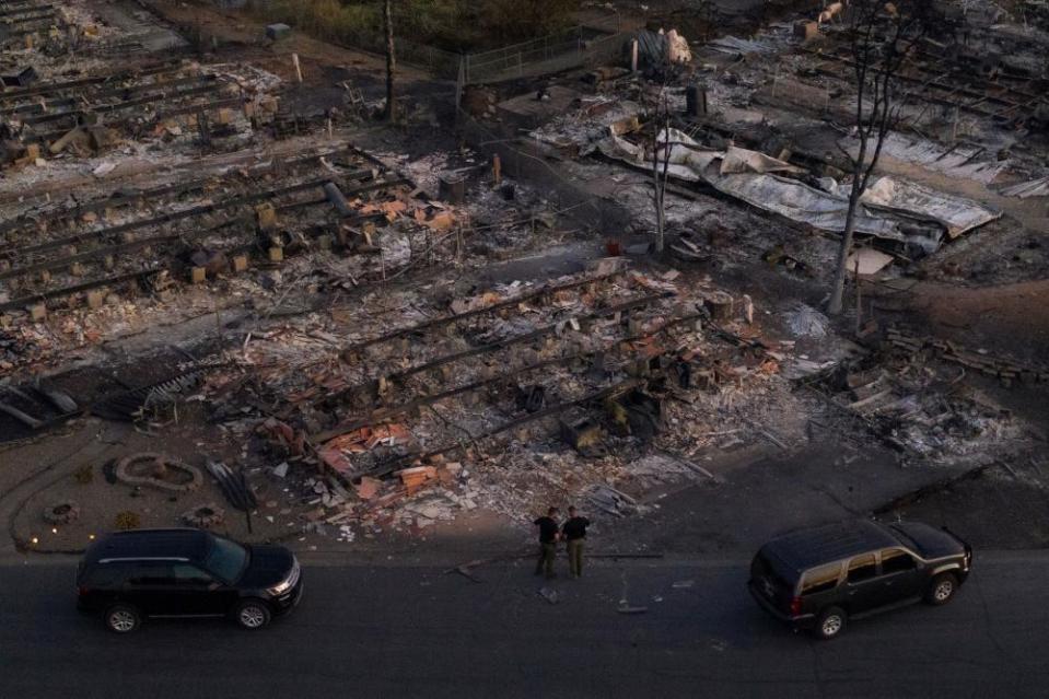 Security officials survey a neighborhood left devastated by the Almeda fire in Phoenix, Oregon.