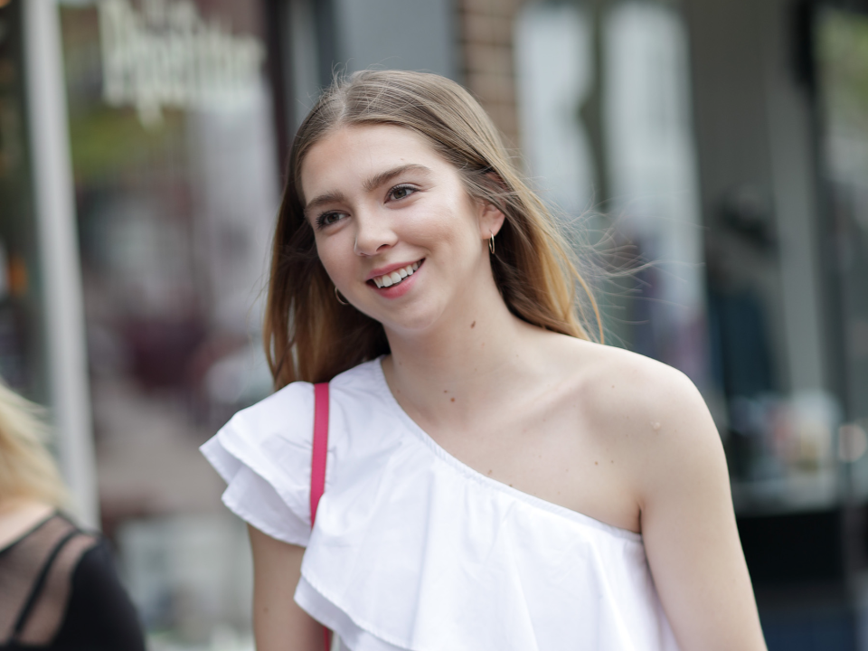 surprised happy young woman outside walking