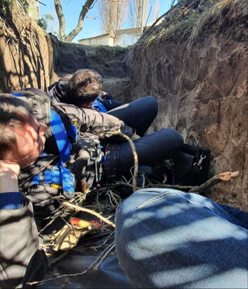 Engineers crouch in a trench near Lyman, Ukraine, during Russian shelling