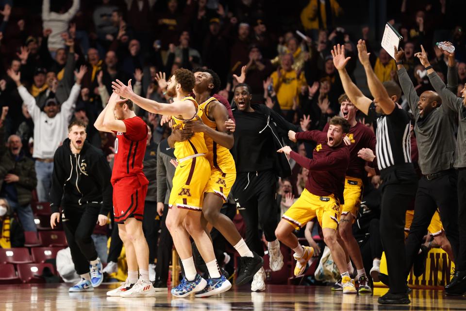 Minnesota Golden Gophers forward Jamison Battle is mobbed by teammates after his game-winning shot against the Rutgers Scarlet Knights during the second half at Williams Arena.