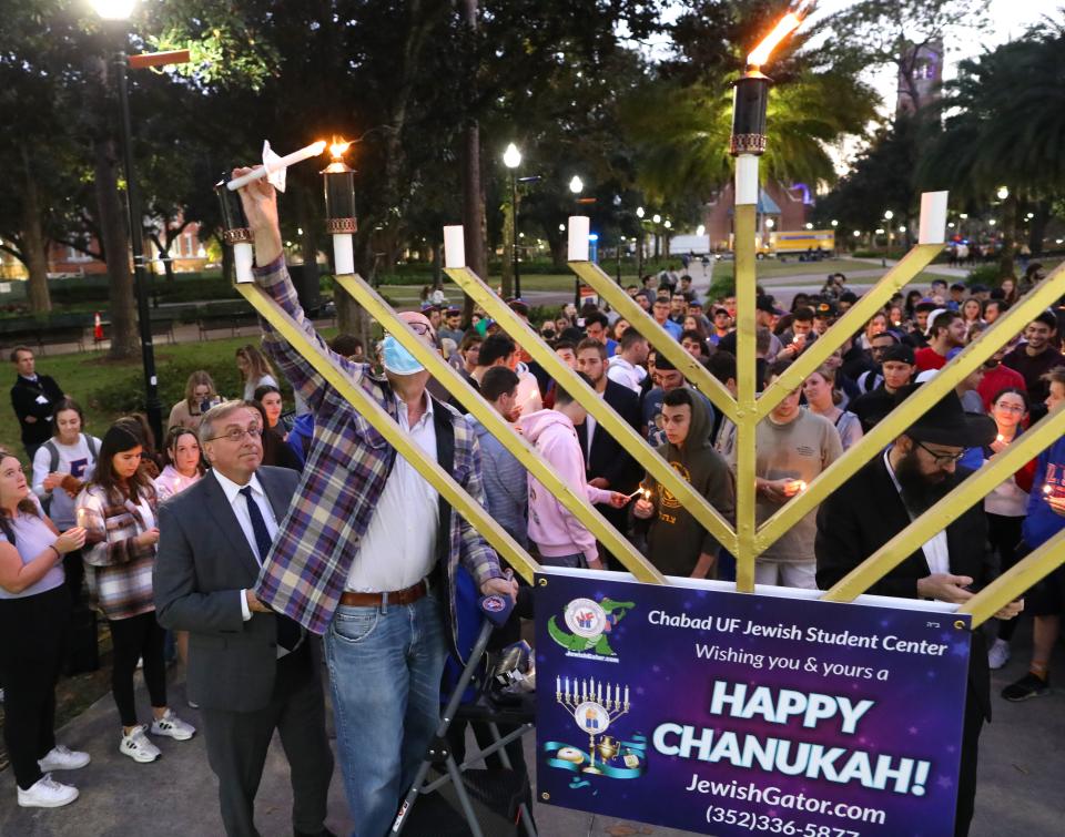 The candles on the giant menorah are lit to celebrate the second night of Hanukkah during a event put on by the Chabad UF Jewish Student Center at the Plaza of the Americas on the University of Florida campus.