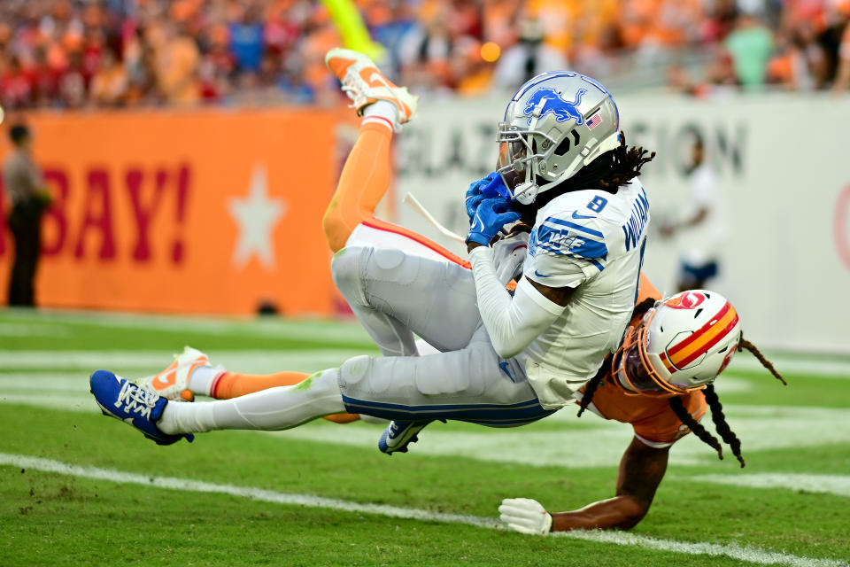 TAMPA, FLORIDA - OCTOBER 15: Jameson Williams #9 of the Detroit Lions catches a touchdown over Ryan Neal #23 of the Tampa Bay Buccaneers during the third quarter at Raymond James Stadium on October 15, 2023 in Tampa, Florida. (Photo by Julio Aguilar/Getty Images)