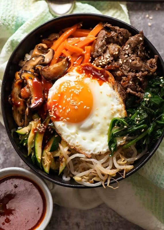 <p>Recipe Tin Eats</p><p>With a mix of seasoned sautéed vegetables, Korean marinated beef and the signature fried egg, the thing that really seals the deal is the bright red, spicy Bibimbap sauce.</p><p><strong>Get the recipe: <a href="https://www.recipetineats.com/bibimbap/" rel="nofollow noopener" target="_blank" data-ylk="slk:Korean Rice Bowl (Bibimbap);elm:context_link;itc:0;sec:content-canvas" class="link ">Korean Rice Bowl (Bibimbap)</a></strong></p>